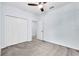 Carpeted bedroom featuring a ceiling fan, closet and entry door at 1262 E 10Th St, Apopka, FL 32703
