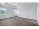 Large bedroom with neutral carpet, tray ceiling, and large windows at 1262 E 10Th St, Apopka, FL 32703