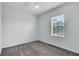 Bedroom features a ceiling fan and a window overlooking lush greenery at 1262 E 10Th St, Apopka, FL 32703