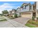 Charming townhomes with two-car garages and brick paver driveways under a bright blue sky at 1262 E 10Th St, Apopka, FL 32703