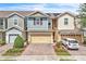 Charming townhome with a two-car garage, brick driveway, and well-maintained landscaping at 1262 E 10Th St, Apopka, FL 32703