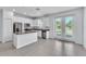 Stylish kitchen with white cabinets, a center island, and modern stainless steel appliances at 1262 E 10Th St, Apopka, FL 32703