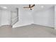 Bright and airy living room featuring tile floors, a ceiling fan, and a staircase at 1262 E 10Th St, Apopka, FL 32703