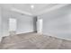 Spacious main bedroom featuring carpet floors, tray ceiling and ensuite bathroom access at 1262 E 10Th St, Apopka, FL 32703