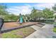 A well-maintained community playground with a slide, climbing features, and a surrounding black metal fence at 1262 E 10Th St, Apopka, FL 32703