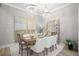 Elegant dining room with modern chandeliers and seating for six at 13437 Granger Ave, Orlando, FL 32827