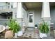 Front porch with seating area, plants and lovely front door at 13437 Granger Ave, Orlando, FL 32827