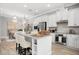 Bright kitchen featuring a marble countertop island and stainless appliances at 13437 Granger Ave, Orlando, FL 32827