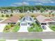 Eye-level view showing the landscaping, solar panels and neighborhood layout in a suburban community at 1397 Gatlin Pl, The Villages, FL 32163