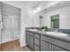 Bathroom featuring double vanity, granite countertop and walk-in shower with glass door at 1397 Gatlin Pl, The Villages, FL 32163