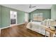 Bedroom featuring ensuite bathroom, ceiling fan and light green walls at 1397 Gatlin Pl, The Villages, FL 32163