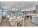 Dining area showing the grey kitchen and blue accent wall at 1397 Gatlin Pl, The Villages, FL 32163