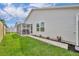 The side of the home boasts a well-kept lawn, landscaping, and a screened-in patio for outdoor enjoyment at 1397 Gatlin Pl, The Villages, FL 32163