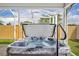 Inviting hot tub with clear water and access steps, enclosed within a screened lanai for privacy at 1397 Gatlin Pl, The Villages, FL 32163