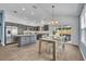 Open kitchen featuring grey cabinets, an island, and stainless steel appliances at 1397 Gatlin Pl, The Villages, FL 32163