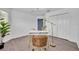 Bright office with wood flooring, modern desk and a view through the window at 1397 Gatlin Pl, The Villages, FL 32163