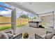 Covered patio with a hot tub and outdoor seating at 1397 Gatlin Pl, The Villages, FL 32163
