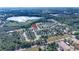 An aerial view shows a community near a lake, surrounded by green forests, with an arrow pointing to a property at 1405 Osprey Ridge Dr, Eustis, FL 32736