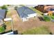 Aerial view of a spacious backyard, featuring a covered patio and fence at 1405 Osprey Ridge Dr, Eustis, FL 32736