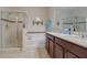 Well-lit bathroom with double sink vanity, garden tub and glass enclosed shower at 1405 Osprey Ridge Dr, Eustis, FL 32736