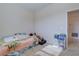 Bedroom with carpet, small bed, and wall shelves for storage and decor at 1405 Osprey Ridge Dr, Eustis, FL 32736