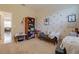 Bedroom with gold polka dot walls, a bookshelf, bench, and neutral carpet at 1405 Osprey Ridge Dr, Eustis, FL 32736