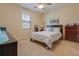 Cozy bedroom with neutral walls, ceiling fan, large window, and comfortable bed at 1405 Osprey Ridge Dr, Eustis, FL 32736