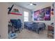 Bedroom with California Republic flag and tapestry, featuring a desk and gaming chair at 1405 Osprey Ridge Dr, Eustis, FL 32736