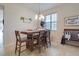 Cozy dining area featuring tile flooring, a modern chandelier, and a wooden table at 1405 Osprey Ridge Dr, Eustis, FL 32736