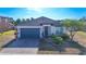 Charming single-story home with a brick driveway and well-maintained landscaping at 1405 Osprey Ridge Dr, Eustis, FL 32736