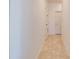 Hallway features neutral tile flooring, white walls and trim, and multiple doorways at 1405 Osprey Ridge Dr, Eustis, FL 32736