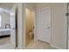 Hallway with tile flooring leading to a bathroom, shower and bedroom at 1405 Osprey Ridge Dr, Eustis, FL 32736