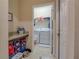 Laundry room features a counter, storage shelves, and a washer and dryer at 1405 Osprey Ridge Dr, Eustis, FL 32736