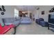 Open-concept living room flows into kitchen with neutral tile flooring and plenty of space for seating at 1405 Osprey Ridge Dr, Eustis, FL 32736