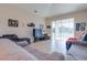 Spacious living room features neutral tile flooring and sliding glass doors leading to the backyard at 1405 Osprey Ridge Dr, Eustis, FL 32736