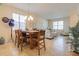 Open-concept living space with tile flooring connecting dining and living areas for seamless flow at 1405 Osprey Ridge Dr, Eustis, FL 32736
