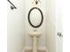 Half bath with pedestal sink, decorative mirror and light fixture at 1441 Twin Trees Ln, Sanford, FL 32771