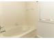 Bathroom featuring a white tub with tiled walls and small window at 1441 Twin Trees Ln, Sanford, FL 32771