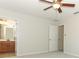 Bedroom featuring neutral carpet, ceiling fan and en suite bathroom at 1441 Twin Trees Ln, Sanford, FL 32771