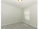 This bedroom features gray carpet, neutral walls, and a sunny window at 1441 Twin Trees Ln, Sanford, FL 32771