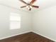 Bedroom featuring wood floors, a ceiling fan, and a window at 1441 Twin Trees Ln, Sanford, FL 32771