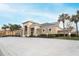 Community clubhouse set against palm trees, offering residents a social hub and recreational facilities at 1441 Twin Trees Ln, Sanford, FL 32771