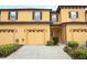 Inviting two-story townhouse with a two-car garage and well-maintained landscaping at 1441 Twin Trees Ln, Sanford, FL 32771