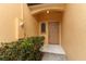 Close-up of a neutral-toned front door with covered entrance and adjacent window at 1441 Twin Trees Ln, Sanford, FL 32771