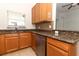 Kitchen area featuring stainless steel appliances, granite countertops, and wood cabinets at 1441 Twin Trees Ln, Sanford, FL 32771