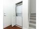 Hall laundry closet with stacked washer and dryer next to stairs at 1441 Twin Trees Ln, Sanford, FL 32771