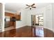 Bright living room with hardwood floors, sliding glass doors, and an adjacent kitchen at 1441 Twin Trees Ln, Sanford, FL 32771