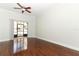 Bright living room with wood floors, ceiling fan, and sliding glass doors to the outside at 1441 Twin Trees Ln, Sanford, FL 32771
