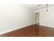A spacious living room features hardwood floors, white trim, and an open doorway at 1441 Twin Trees Ln, Sanford, FL 32771
