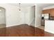 Open-concept living space with hardwood floors, stairs, and an adjacent kitchen area at 1441 Twin Trees Ln, Sanford, FL 32771